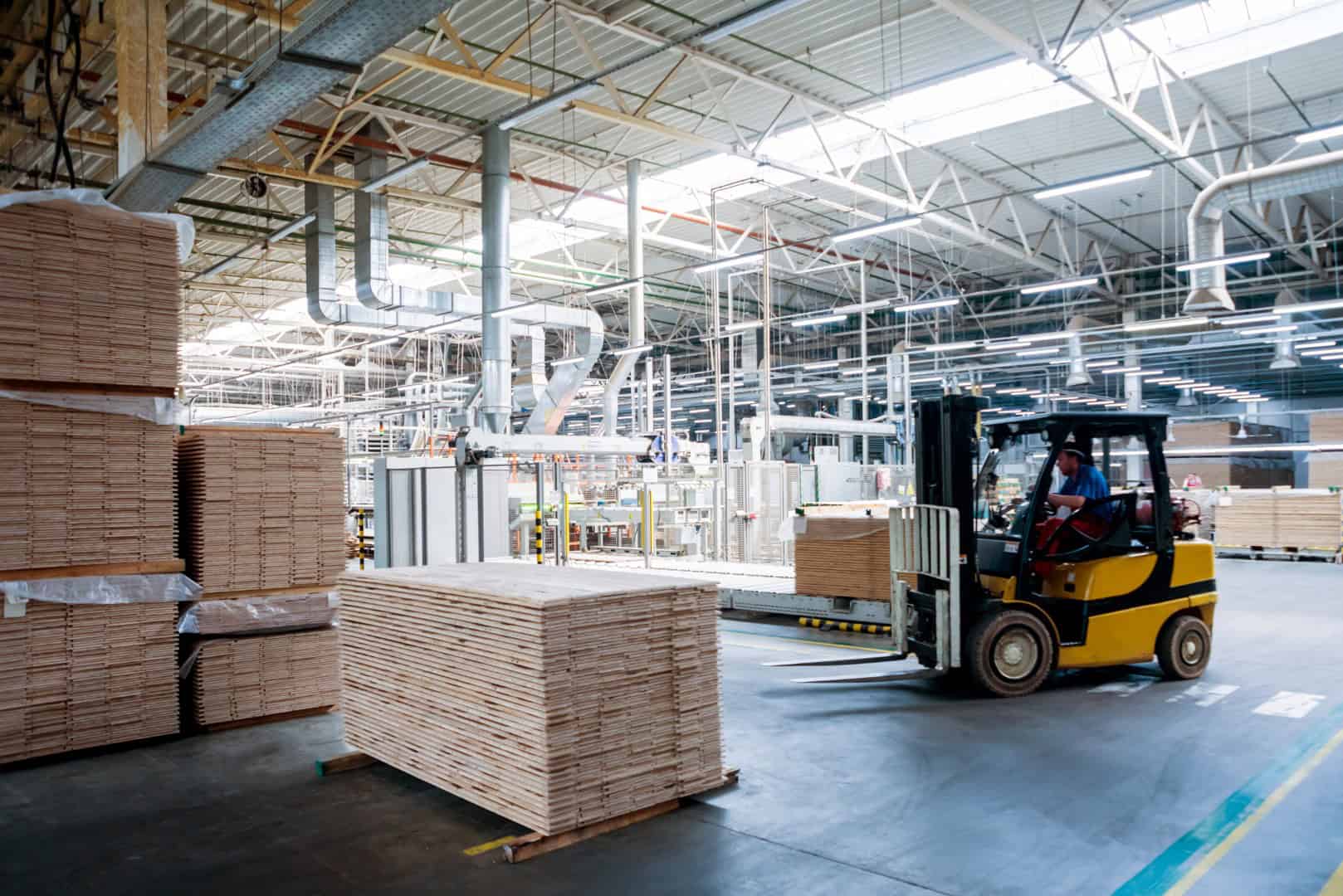 Forklift loader in storage warehouse ship yard.